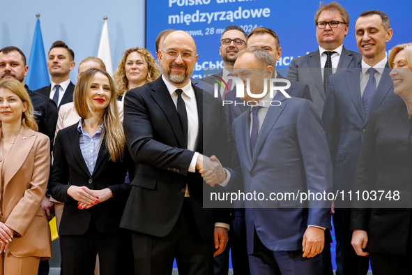 Prime Minister of Poland, Donald Tusk and Prime Minister of Ukraine, Denys Shmyhal (middle) pose with their cabinets for a family photo as U...