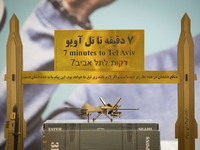 3D models of Iranian missiles and a drone are being placed under an anti-Israeli placard in the Imam Khomeini Grand Mosque during the 31st e...