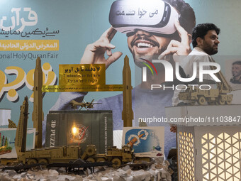3D models of Iranian missiles and a drone are being placed under an anti-Israeli placard in the Imam Khomeini Grand Mosque during the 31st e...