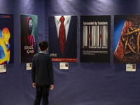 A young Iranian boy is looking at anti-Israeli posters in the Imam Khomeini Grand Mosque during the 31st edition of the International Holy Q...