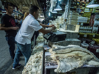 People are searching for fish at the Municipal Market on the eve of Good Friday in Sao Paulo, Brazil, on March 28, 2024. (