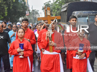 Children are carrying a cross during a rally organized to observe Good Friday in Kolkata, India, on March 29, 2024. (