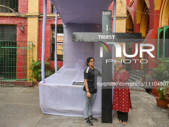 Two ladies are holding a large cross inside a church on Good Friday in Kolkata, India, on March 29, 2024. (