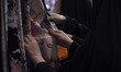 Iranian veiled women are looking at chador fabric while shopping at the Hijab and Chastity...