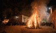 People looking at a fire in a square are seen during Good Friday procession in Gubbio, Ita...