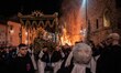 Dead Christ statue is seen next to a giant fire during Good Friday procession in Gubbio, I...