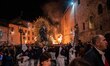 A statue of Our Lady of Sorrows is seen next to a fire during Good Friday procession in Gu...