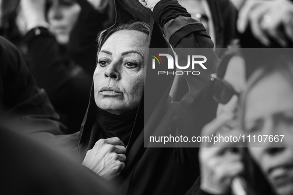 (EDITOR'S NOTE: Image was converted to black and white) One of the women in the procession is lowering the veil over her face during the pro...