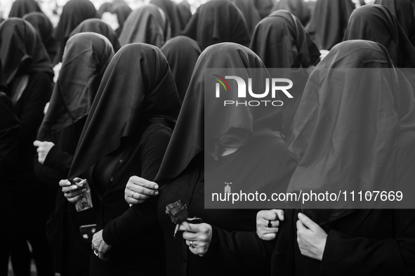 (EDITOR'S NOTE: Image was converted to black and white) Women are covering their faces during the procession for the Madonna Desolata in Can...
