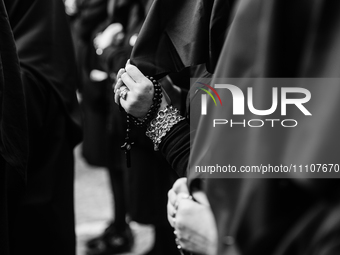(EDITOR'S NOTE: Image was converted to black and white) Women are holding rosaries during the procession for the Madonna Desolata in Canosa...