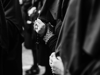 (EDITOR'S NOTE: Image was converted to black and white) Women are holding rosaries during the procession for the Madonna Desolata in Canosa...