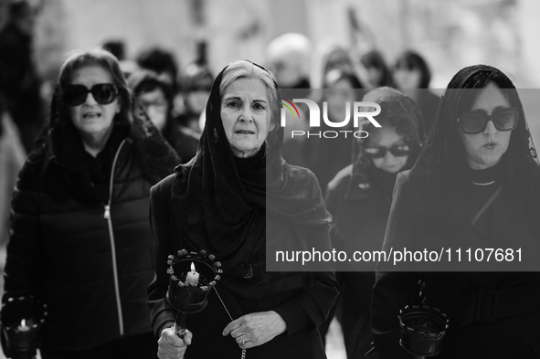 (EDITOR'S NOTE: Image was converted to black and white) Women are standing in front of the procession for the Madonna Desolata in Canosa di...