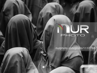 (EDITOR'S NOTE: Image was converted to black and white) Women are singing with their faces covered during the procession for the Madonna Des...
