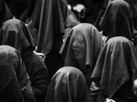(EDITOR'S NOTE: Image was converted to black and white) Women are singing with their faces covered during the procession for the Madonna Des...