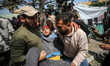 Paramedics are transporting a wounded Palestinian at the Al-Aqsa Martyrs Hospital in Deir...