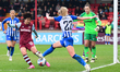 Honoka Hayashi of West Ham United is clearing the ball from Katie Robinson of Brighton and...