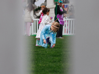 Seen past a fence, a child participates in the 2024 White House Easter Egg Roll on the South Lawn of the White House in Washington, D.C. on...