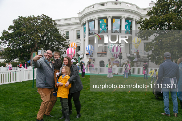 A family takes a photograph during the 2024 White House Easter Egg Roll on the South Lawn of the White House in Washington, D.C. on April 1,...