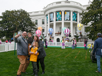 A family takes a photograph during the 2024 White House Easter Egg Roll on the South Lawn of the White House in Washington, D.C. on April 1,...