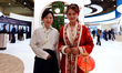 Two women from China Mobile are wearing traditional Chinese clothing at the Mobile World C...