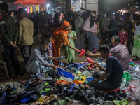 A shoe vendor is selling shoes at a street shop in a low-income area's weekly market ahead of Eid ul Fitr in Dhaka, Bangladesh, on April 4,...