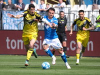 Flavio Bianchi of Brescia Calcio FC is being challenged by Stefano Moreo of Pisa Sporting Club 1909 during the Italian Serie B soccer champi...
