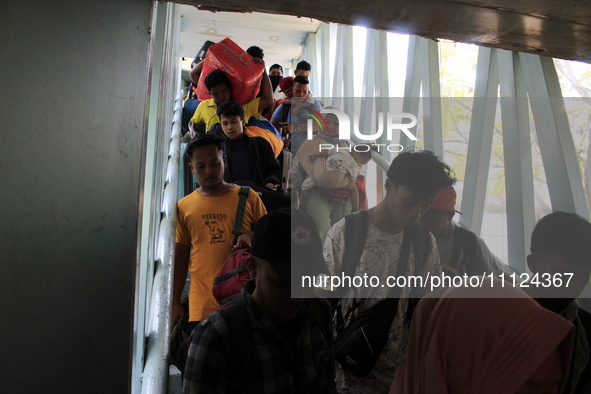 Passengers from the Indonesian shipping vessel PELNI, KM Kelud, which originated from the Batam Islands, are disembarking at the Belawan por...