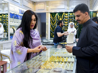 A woman is shopping for jewelry at the Doha Gold Souq ahead of Eid al-Fitr, which marks the end of the holy month of Ramadan, in Doha, Qatar...