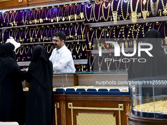 Women are shopping for jewelry at the Doha Gold Souq ahead of Eid al-Fitr, which marks the end of the holy month of Ramadan, in Doha, Qatar,...