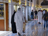Customers are walking to a gold jewelry shop in the Doha Gold Souq ahead of Eid al-Fitr, which marks the end of the holy month of Ramadan, i...