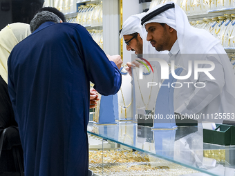 People are shopping for jewelry at the Doha Gold Souq ahead of Eid al-Fitr, which marks the end of the holy month of Ramadan, in Doha, Qatar...