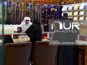 Women are shopping for jewelry at the Doha Gold Souq ahead of Eid al-Fitr, which marks the end of the holy month of Ramadan, in Doha, Qatar,...