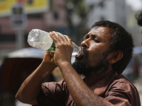 A rickshaw puller is drinking water to find relief from a heatwave in Dhaka, Bangladesh, on April 6, 2024. The Met Office reports that Bangl...