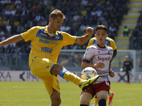 Simone Romagnoli of Frosinone is kicking the ball past Kacper Urbanski of Bologna during the Serie A soccer match between SSC Frosinone Calc...