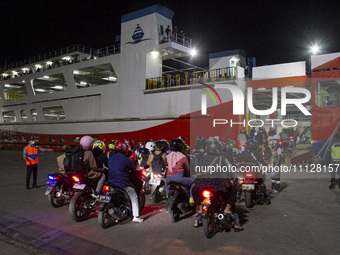 Motorbike riders are boarding a ship at Ciwandan Port in Cilegon City, Banten, Indonesia, on April 7, 2024, that will take them to their hom...