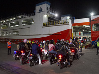 Motorbike riders are boarding a ship at Ciwandan Port in Cilegon City, Banten, Indonesia, on April 7, 2024, that will take them to their hom...
