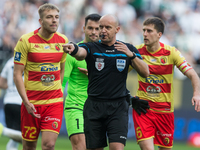 Mateusz Skrzypczak, Zlatan Alomerovic, referee Szymon Marciniak, and Taras Romanczuk are participating in the Legia Warsaw vs Jagiellonia PK...