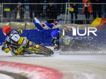 Heikki Huusko of Finland, wearing red and numbered 67, is passing Stefan Svensson of Sweden, in blue with the number 58, during the FIM Ice...