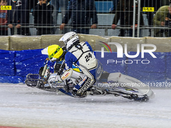 Sweden's Jimmy Olsen, wearing number 81 in yellow, is passing Finland's Max Koivula, number 24 in white, during the FIM Ice Speedway Gladiat...