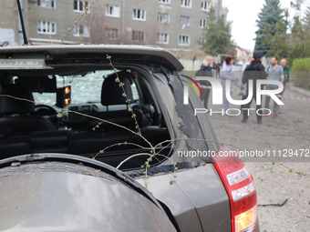 A car with a broken rear window is pictured after a Russian precision-guided munition struck civil infrastructure in Kharkiv, northeastern U...