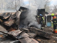 Firefighters are putting out a fire with water after a Russian precision-guided munition hit civil infrastructure in Kharkiv, northeastern U...
