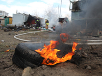 A car tire is burning after a Russian precision-guided munition hit civil infrastructure in Kharkiv, northeastern Ukraine, on April 7, 2024....