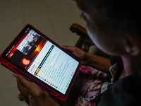 A Sri Lankan student is watching the total solar eclipse live on NASA's YouTube channel in Ratnapura, Sri Lanka, on April 8, 2024. The total...