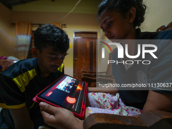 Sri Lankan students are watching the total solar eclipse live on NASA's YouTube channel in Ratnapura, Sri Lanka, on April 8, 2024. The total...