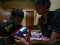 Sri Lankan students are watching the total solar eclipse live on NASA's YouTube channel in Ratnapura, Sri Lanka, on April 8, 2024. The total...