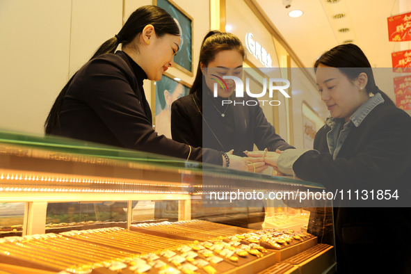 Customers are shopping for gold jewelry at a gold store in the Lianyun district, in Lianyungang, China, on April 9, 2024. 