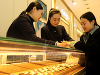 Customers are shopping for gold jewelry at a gold store in the Lianyun district, in Lianyungang, China, on April 9, 2024. (