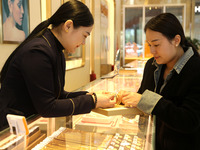 Customers are shopping for gold jewelry at a gold store in the Lianyun district, in Lianyungang, China, on April 9, 2024. (