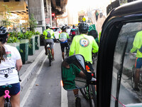 Cyclists are accompanying a man who is driving an electric tricycle during a ride-out protest to the headquarters of the Metro Manila Develo...