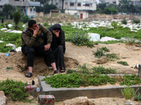 Palestinians are gathering at a cemetery on the grave of a relative early on the first day of Eid al-Fitr, the Muslim holiday that begins at...